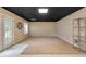 An unfinished basement with carpet, shelving, and walk-out access at 303 Fireside Trl, Douglasville, GA 30134