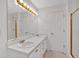 Bright bathroom featuring a double vanity, a shower with gold trim, and updated fixtures at 303 Fireside Trl, Douglasville, GA 30134