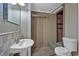 Bathroom with a toilet, sink, and mirror with tile wall accents at 303 Fireside Trl, Douglasville, GA 30134
