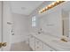Bathroom featuring a double vanity, a soaking tub, and updated fixtures at 303 Fireside Trl, Douglasville, GA 30134