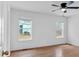 Bedroom with ceiling fan, hardwood floors, neutral paint, and multiple windows at 303 Fireside Trl, Douglasville, GA 30134