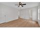 Bright bedroom featuring hardwood floors, white walls, a ceiling fan, and ample natural light at 303 Fireside Trl, Douglasville, GA 30134