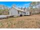 Exterior view of house showing rear facade, roof, and side of carport at 303 Fireside Trl, Douglasville, GA 30134