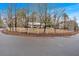 Exterior shot of the home, partially surrounded by a white fence and trees at 303 Fireside Trl, Douglasville, GA 30134