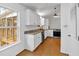 Charming kitchen with white cabinets, granite counters, stainless steel appliances and hardwood floors at 303 Fireside Trl, Douglasville, GA 30134