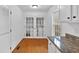 Bright kitchen area featuring wood floors, granite counters, and french doors to laundry room at 303 Fireside Trl, Douglasville, GA 30134