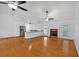 Open concept living room with fireplace, modern lighting, and stainless steel appliances at 303 Fireside Trl, Douglasville, GA 30134