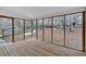 A screened-in porch with wood flooring and a view of the backyard at 303 Fireside Trl, Douglasville, GA 30134