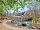 Landscaped backyard featuring patio, trees, manicured garden, and Adirondack seating area at 3304 Woolbridge Ct, Marietta, GA 30062
