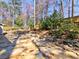 Beautiful stone patio featuring rock wall and lush landscaping at 3304 Woolbridge Ct, Marietta, GA 30062