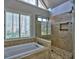 Updated bathroom features a glass shower, soaking tub and tiled flooring with natural light at 3304 Woolbridge Ct, Marietta, GA 30062