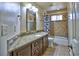 Updated bathroom with granite counters, tiled shower and tub combo, and modern fixtures at 3304 Woolbridge Ct, Marietta, GA 30062