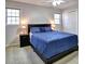 Comfortable bedroom featuring a queen bed with blue bedding, two windows and grey walls at 3304 Woolbridge Ct, Marietta, GA 30062