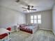 Bright bedroom with a white wood bed and colorful quilt, desk and red chair at 3304 Woolbridge Ct, Marietta, GA 30062