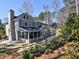Expansive exterior of home featuring sunroom, lush landscaping, and neutral paint at 3304 Woolbridge Ct, Marietta, GA 30062