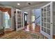 Spacious room showcasing hardwood floors and French doors with an easy transition to other parts of the house at 3304 Woolbridge Ct, Marietta, GA 30062