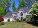Well-maintained two-story home with a pristine lawn, mature trees, and beautiful landscaping, offering great curb appeal at 3304 Woolbridge Ct, Marietta, GA 30062