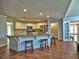 Open concept kitchen with granite island, stainless appliances, breakfast bar, and modern lighting at 3304 Woolbridge Ct, Marietta, GA 30062