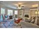Comfortable living room featuring built-in shelving, ceiling fan, area rug, sofa and chairs at 3304 Woolbridge Ct, Marietta, GA 30062