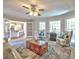 Cozy living room featuring french doors to kitchen, ceiling fan, windows, area rug and comfortable seating at 3304 Woolbridge Ct, Marietta, GA 30062