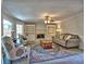Comfortable living room with fireplace, built-in shelving, area rug, ceiling fan, sofa and chairs at 3304 Woolbridge Ct, Marietta, GA 30062