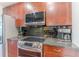 A kitchen featuring stainless steel appliances and dark subway tile backsplash at 400 W Peachtree Nw St # 3412, Atlanta, GA 30308
