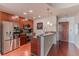 Modern kitchen with stainless steel appliances, granite countertops, and rich wood cabinets at 400 W Peachtree Nw St # 3412, Atlanta, GA 30308