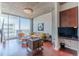 Living room with hardwood floors, a large window, and modern furnishings at 400 W Peachtree Nw St # 3412, Atlanta, GA 30308