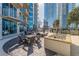 Outdoor patio with tables, chairs, and lush landscaping, perfect for relaxing or entertaining guests in upscale urban setting at 400 W Peachtree Nw St # 3412, Atlanta, GA 30308