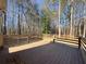 Wood back deck overlooking a wooded area at 410 Invector Ct, Locust Grove, GA 30248