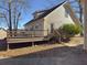 Wooden back deck with a partial view of the house's exterior and a wooded area at 410 Invector Ct, Locust Grove, GA 30248