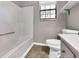 Bathroom with tile flooring, a shower and bathtub combo, and natural light from the window at 410 Invector Ct, Locust Grove, GA 30248