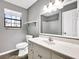Bathroom features a modern vanity, neutral tones, and natural light from the window at 410 Invector Ct, Locust Grove, GA 30248