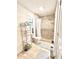 Well-lit bathroom showcases a tiled shower, modern toilet, and shelving for storage at 410 Invector Ct, Locust Grove, GA 30248