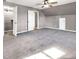 Spacious bedroom featuring plush carpeting, a ceiling fan, and walk-in closets, providing ample storage at 410 Invector Ct, Locust Grove, GA 30248