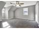 A neutral-toned bedroom with soft carpeting, a ceiling fan, and bright windows, creating a cozy and inviting atmosphere at 410 Invector Ct, Locust Grove, GA 30248