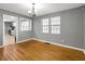 Bright dining room with hardwood floors, neutral walls, and seamless transitions to other rooms at 410 Invector Ct, Locust Grove, GA 30248