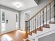Bright entryway featuring wood floors, staircase, and modern finishes at 410 Invector Ct, Locust Grove, GA 30248