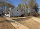 Charming home with sidewalk and driveway, surrounded by mature trees at 410 Invector Ct, Locust Grove, GA 30248