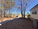 Home exterior view with a paved driveway and natural surroundings at 410 Invector Ct, Locust Grove, GA 30248