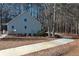Home exterior view showcasing the private driveway and natural surroundings at 410 Invector Ct, Locust Grove, GA 30248