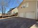 View of the home's back yard with a deck and a two-car garage at 410 Invector Ct, Locust Grove, GA 30248