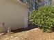 Beige vinyl sided house with a white door and green foliage at 410 Invector Ct, Locust Grove, GA 30248