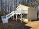 Exterior view showcasing a detached garage, stairs, and natural surroundings at 410 Invector Ct, Locust Grove, GA 30248