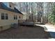 Exterior view showing a partial wooden deck and detached garage, showcasing ample outdoor space at 410 Invector Ct, Locust Grove, GA 30248