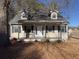 Charming home with a inviting front porch and classic architectural details at 410 Invector Ct, Locust Grove, GA 30248