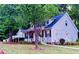 Lovely home with a charming front porch and well-maintained lawn at 410 Invector Ct, Locust Grove, GA 30248
