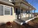 Spacious covered porch with wood floors and support posts at 410 Invector Ct, Locust Grove, GA 30248