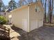 Exterior of the three-car garage showing a back stairway at 410 Invector Ct, Locust Grove, GA 30248