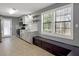 Well-lit kitchen with stainless steel appliances, tile floors, white cabinetry, and view of nature at 410 Invector Ct, Locust Grove, GA 30248